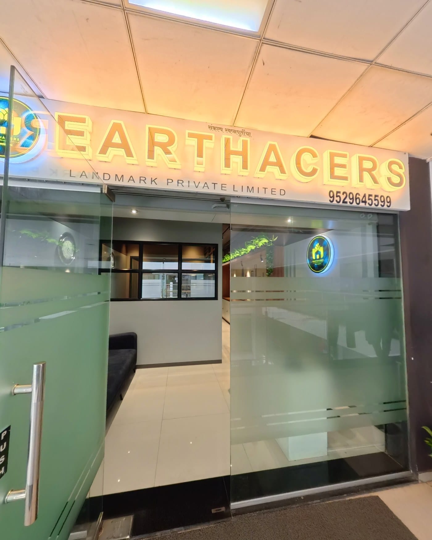 Earthacers Landmark Private Limited office entrance with branded signage