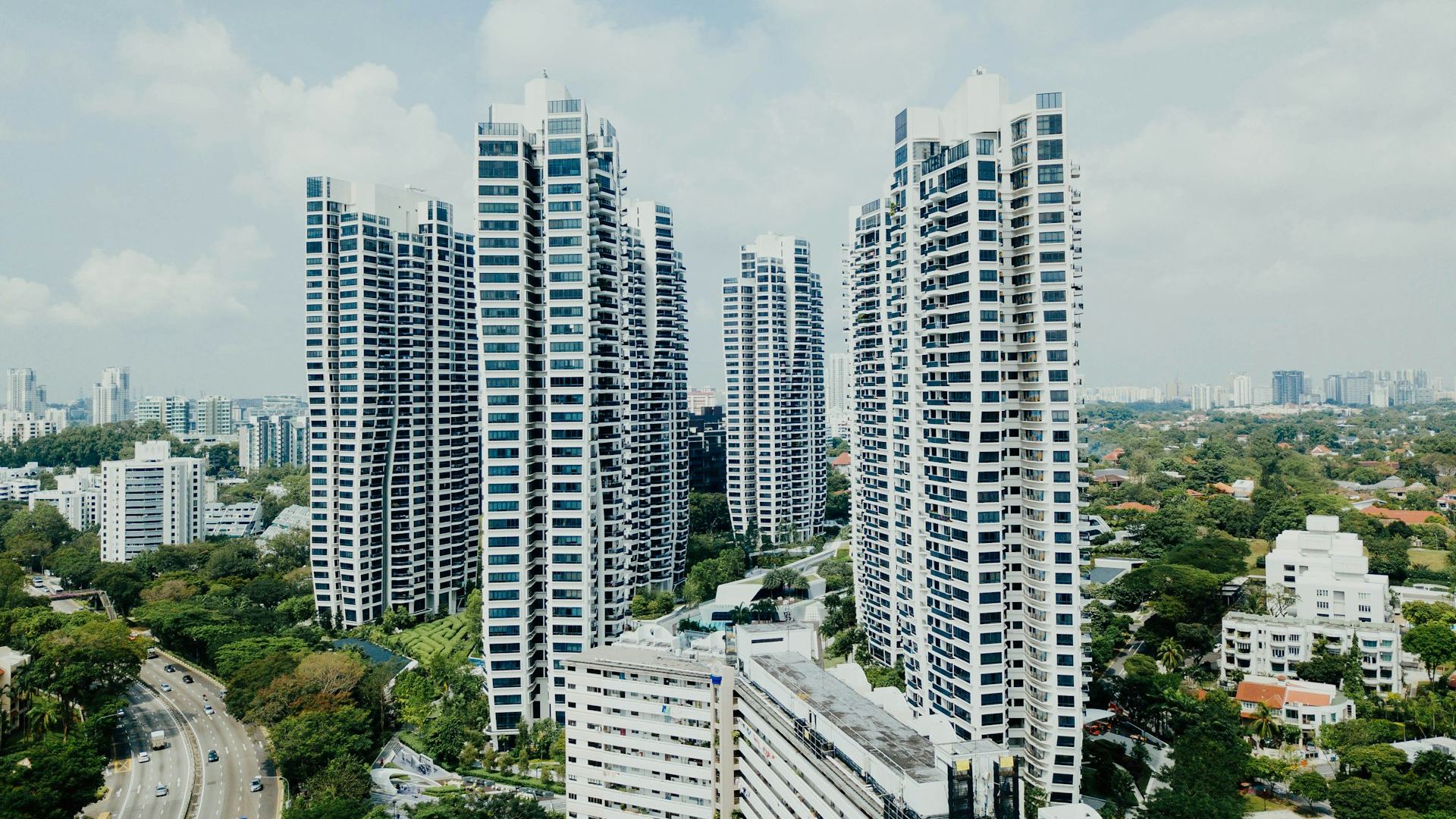 High-rise residential towers surrounded by greenery, representative of urban residential development